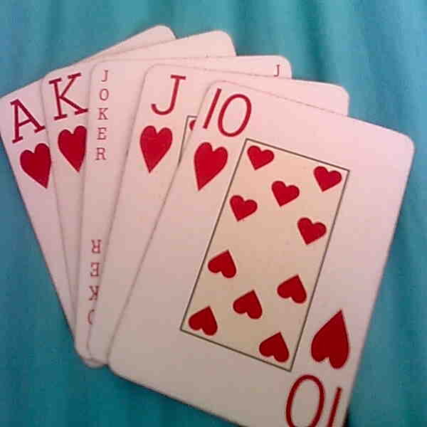 Royal Flush hand with a Joker as Queen in poker game